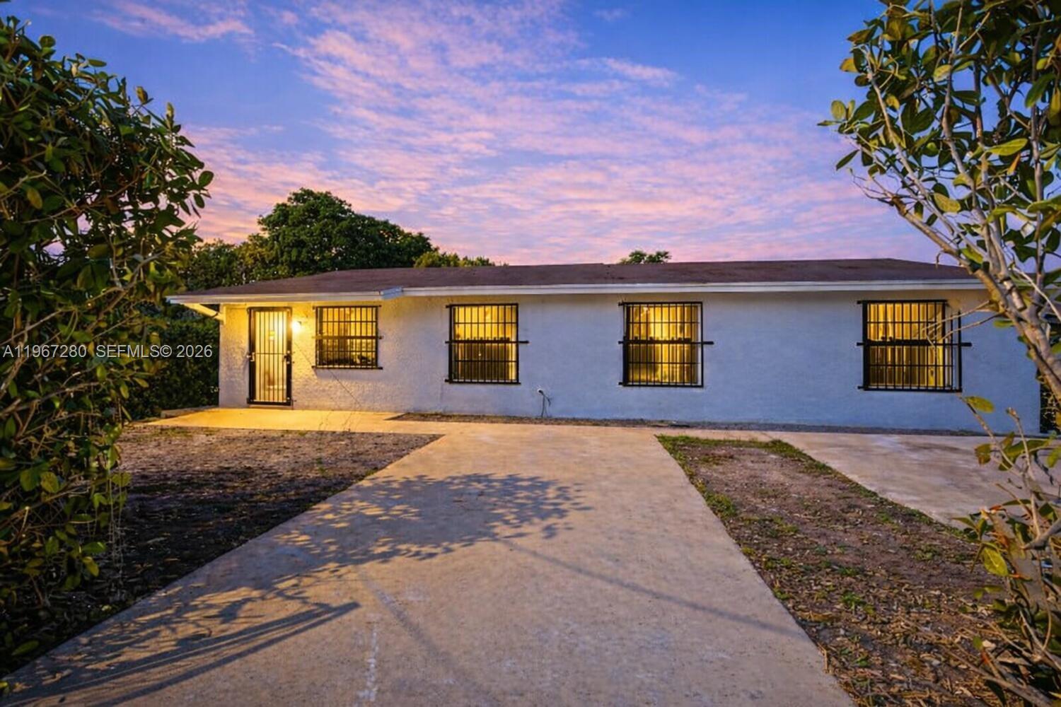 522 Southwest 3rd Avenue Homestead, FL 33030 - Photo 1 of 20 a front view of a house with a yard and garage