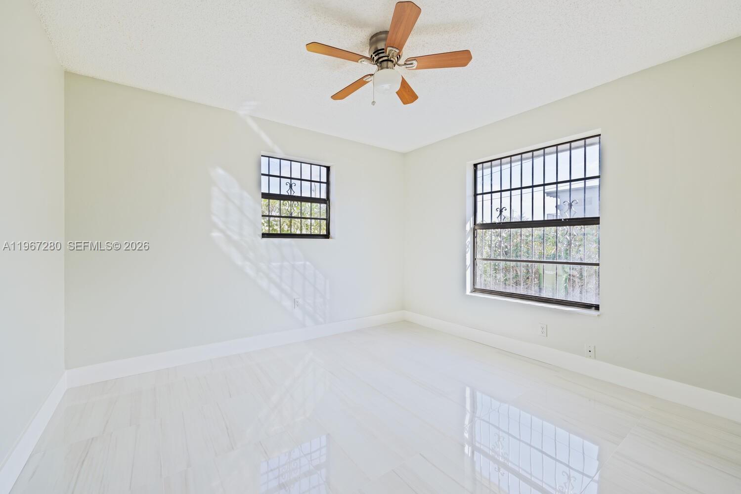 522 Southwest 3rd Avenue Homestead, FL 33030 - Photo 18 of 20 an empty room with windows and fan