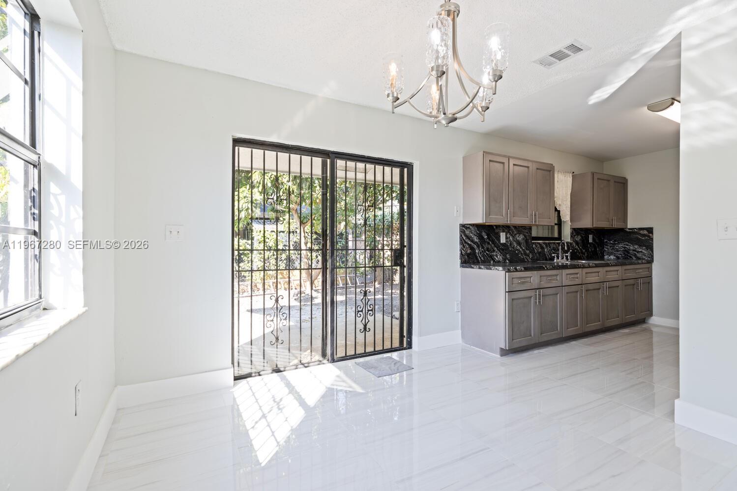 522 Southwest 3rd Avenue Homestead, FL 33030 - Photo 7 of 20 a kitchen with stainless steel appliances granite countertop a stove a sink and a refrigerator