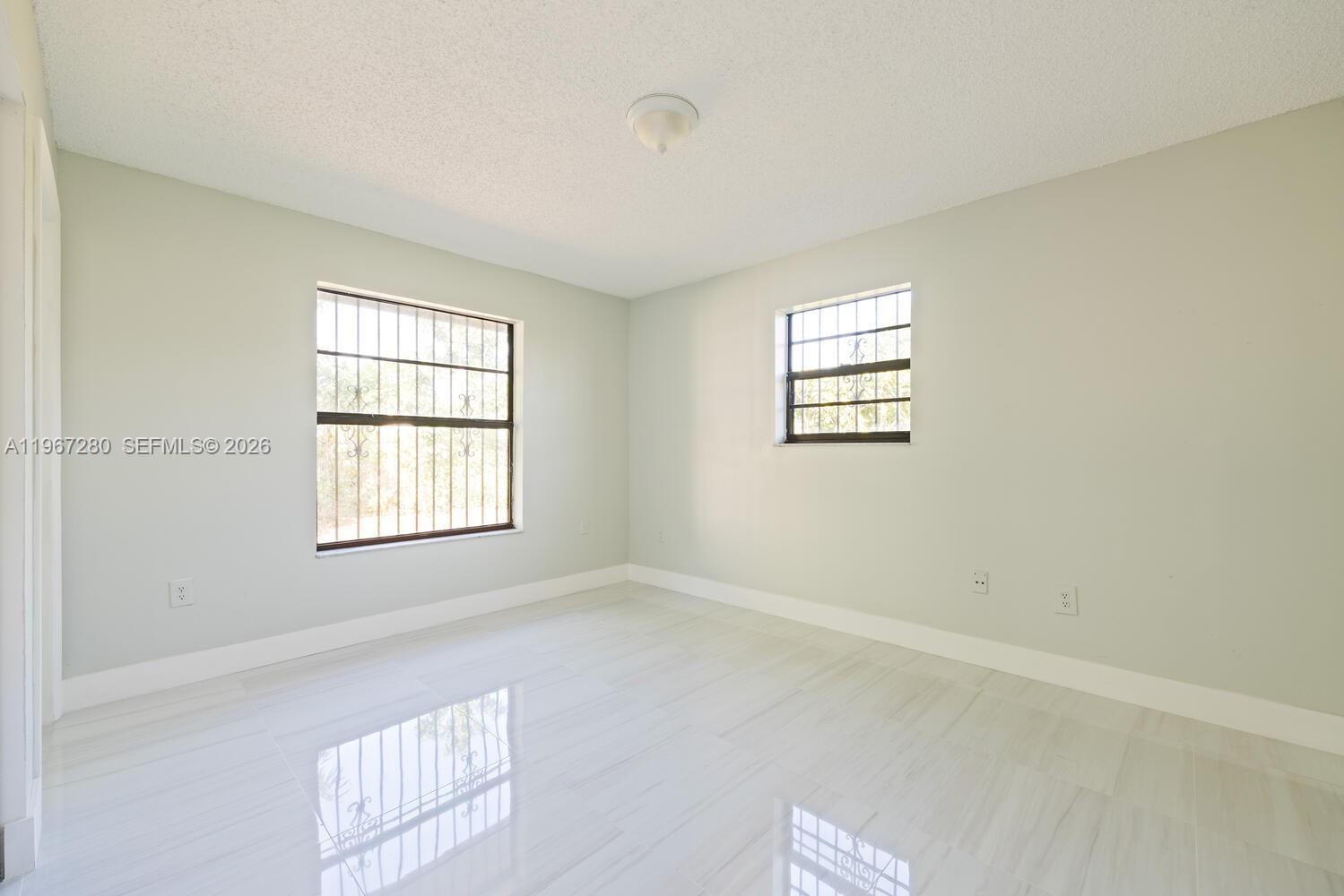 522 Southwest 3rd Avenue Homestead, FL 33030 - Photo 10 of 20 an empty room with windows