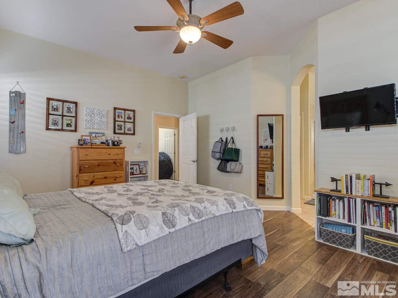 1870 Beringer Way Reno, NV 89521 - Photo 15 of 25 a bedroom with a bed and a flat screen tv