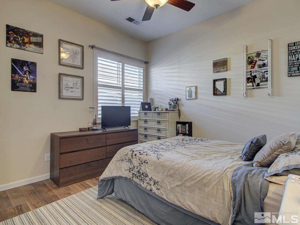 1870 Beringer Way Reno, NV 89521 - Photo 17 of 25 a bedroom with a bed and wooden floor