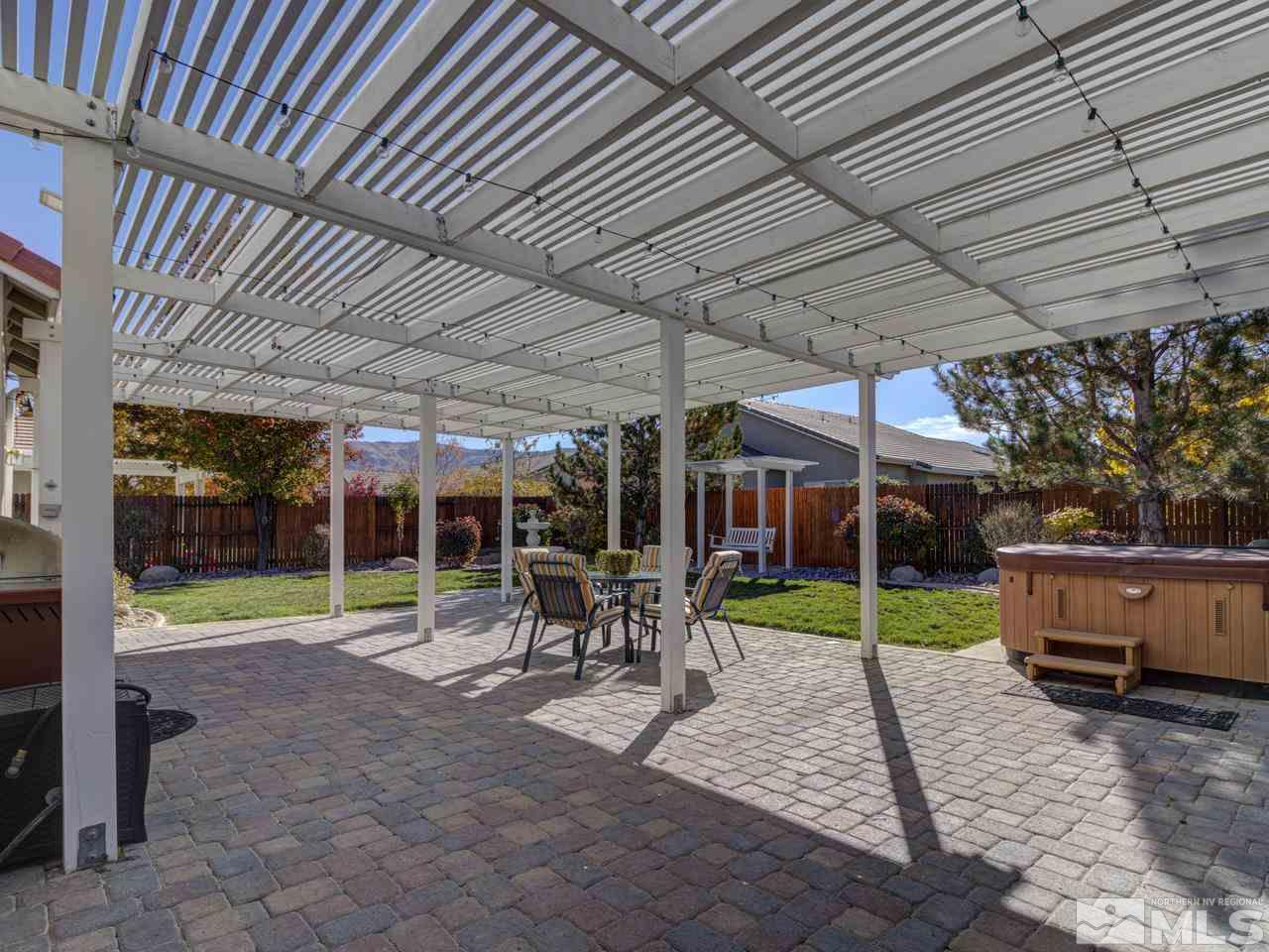 1870 Beringer Way Reno, NV 89521 - Photo 24 of 25 a view of a patio with table and chairs under an umbrella