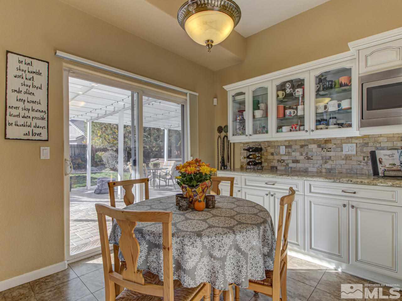 1870 Beringer Way Reno, NV 89521 - Photo 5 of 25 a dining room with stainless steel appliances granite countertop a table and chairs