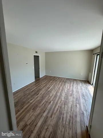 wooden floor in a hall with an empty room