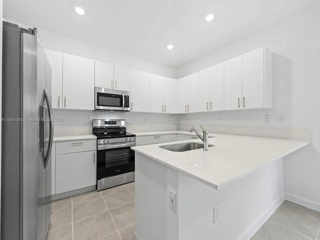a kitchen with a sink a stove and refrigerator