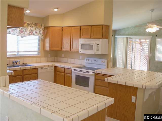 4605 Goodwin Road Sparks, NV 89436 - Photo 3 of 13 a kitchen with a sink stove and refrigerator