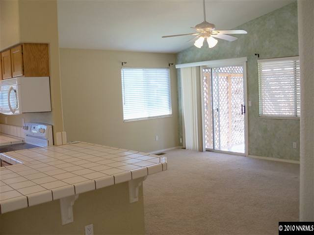 4605 Goodwin Road Sparks, NV 89436 - Photo 6 of 13 a bedroom with a bed and a chandelier