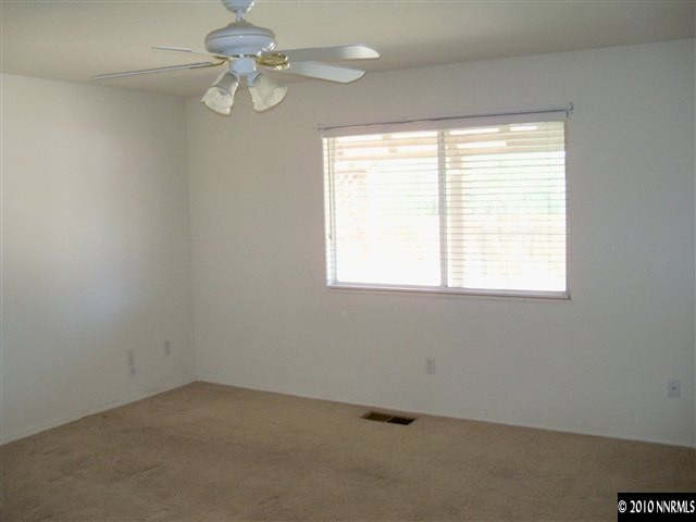 4605 Goodwin Road Sparks, NV 89436 - Photo 8 of 13 an empty room with a window and a fan