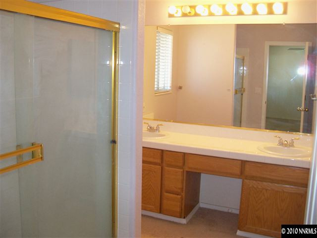 4605 Goodwin Road Sparks, NV 89436 - Photo 9 of 13 a bathroom with a sink and a mirror