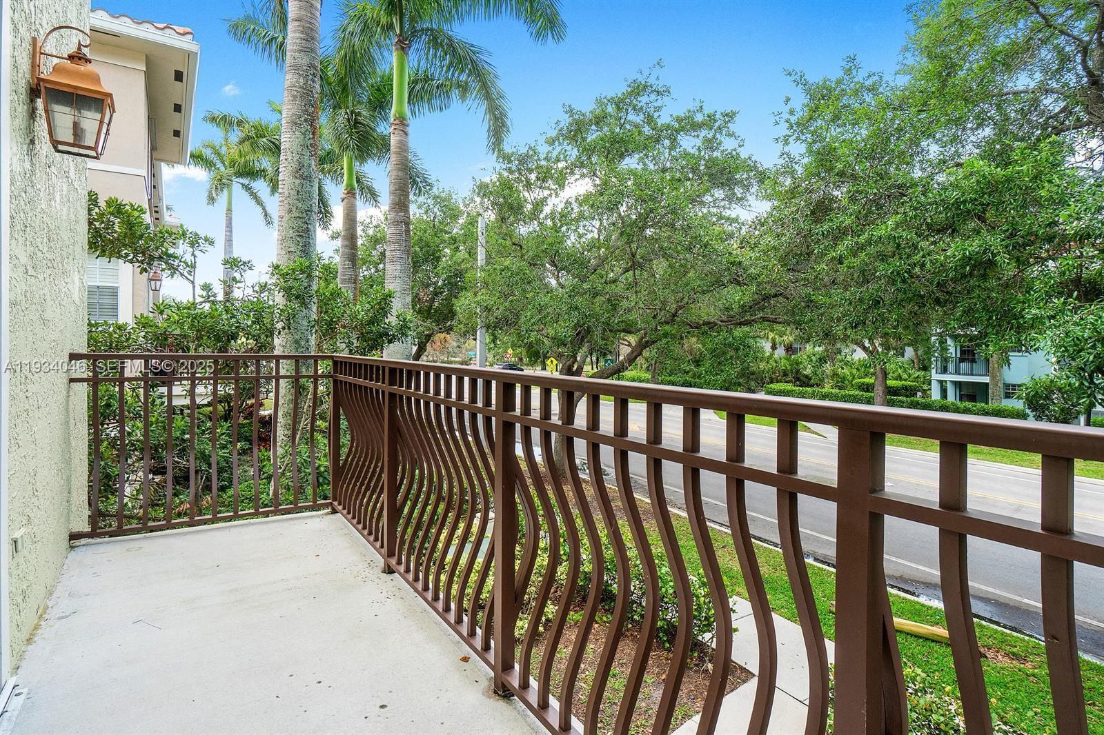 888 University Boulevard Jupiter, FL 33458 - Photo 11 of 41 a balcony with trees in front of it