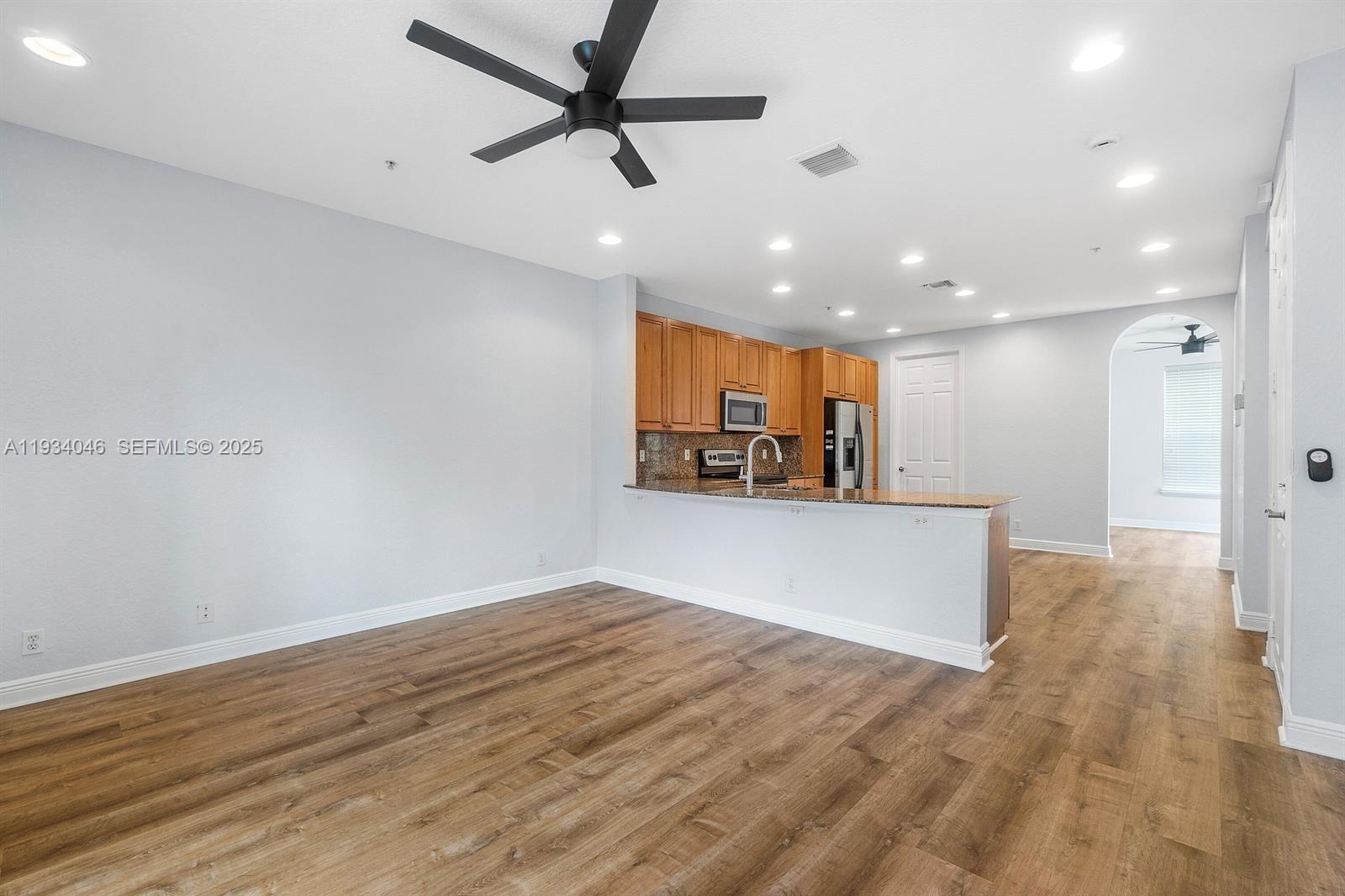 888 University Boulevard Jupiter, FL 33458 - Photo 15 of 41 a view of a kitchen with a sink and a refrigerator