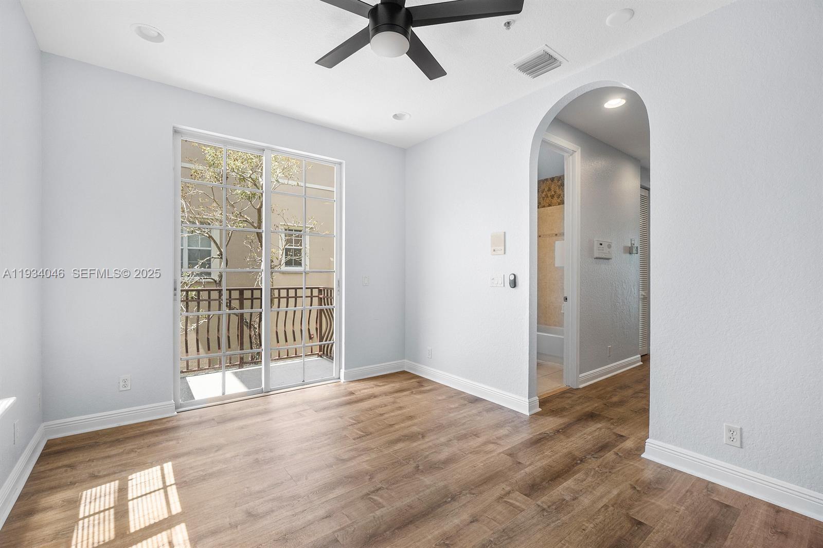888 University Boulevard Jupiter, FL 33458 - Photo 17 of 41 an empty room with wooden floor and windows