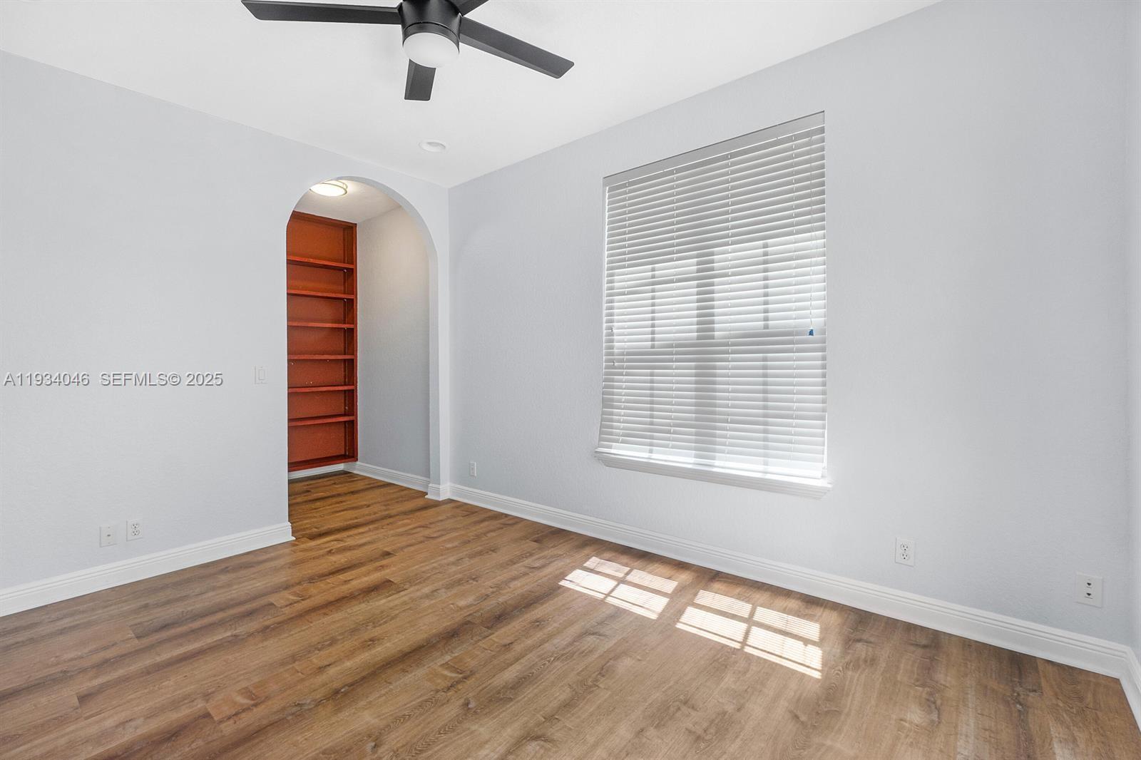888 University Boulevard Jupiter, FL 33458 - Photo 18 of 41 an empty room with wooden floor and windows