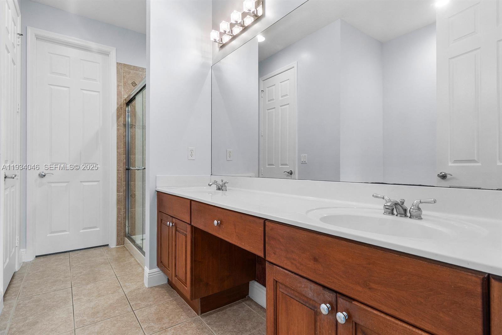 888 University Boulevard Jupiter, FL 33458 - Photo 25 of 41 a bathroom with a double vanity sink mirror and double