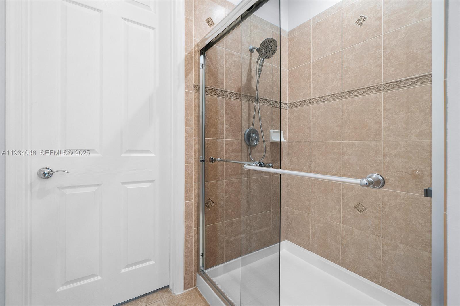 888 University Boulevard Jupiter, FL 33458 - Photo 28 of 41 a bathroom with a glass shower door
