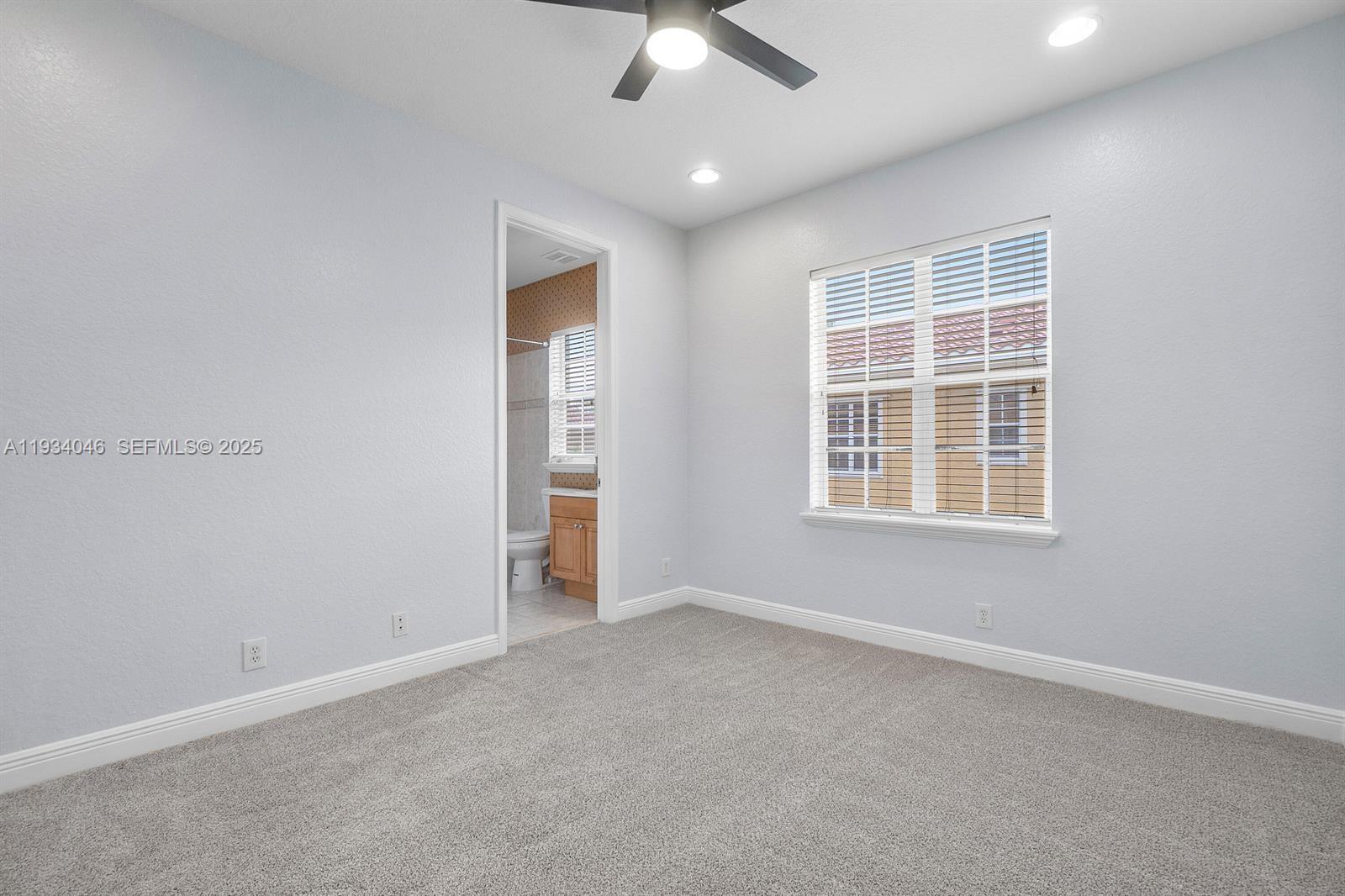 888 University Boulevard Jupiter, FL 33458 - Photo 35 of 41 an empty room with a empty space and a ceiling fan