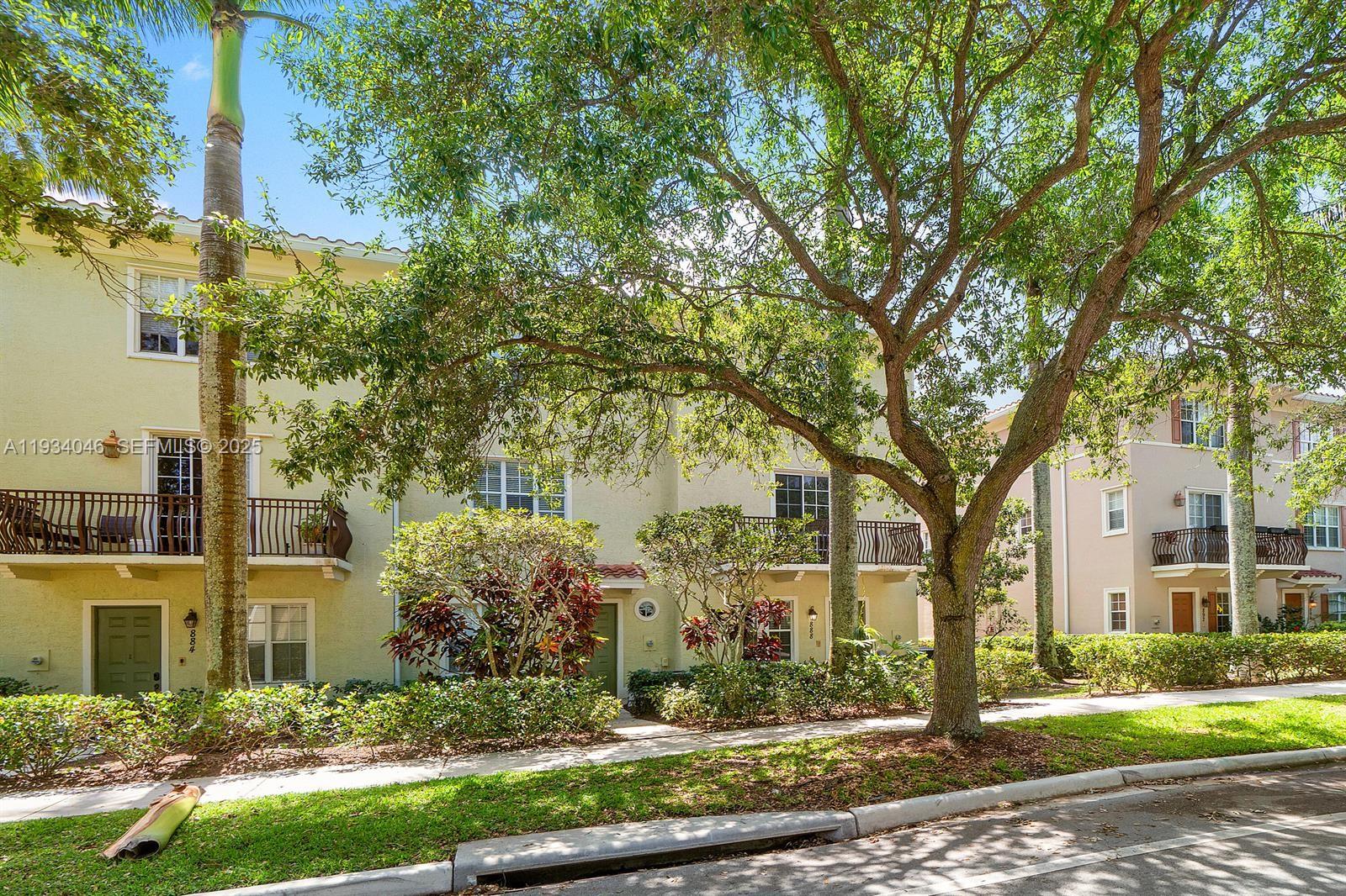 888 University Boulevard Jupiter, FL 33458 - Photo 36 of 41 front view of a building with trees
