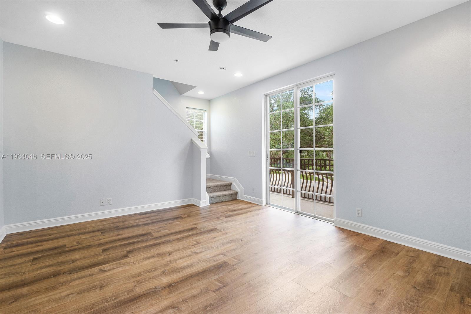 888 University Boulevard Jupiter, FL 33458 - Photo 9 of 41 an empty room with wooden floor and windows