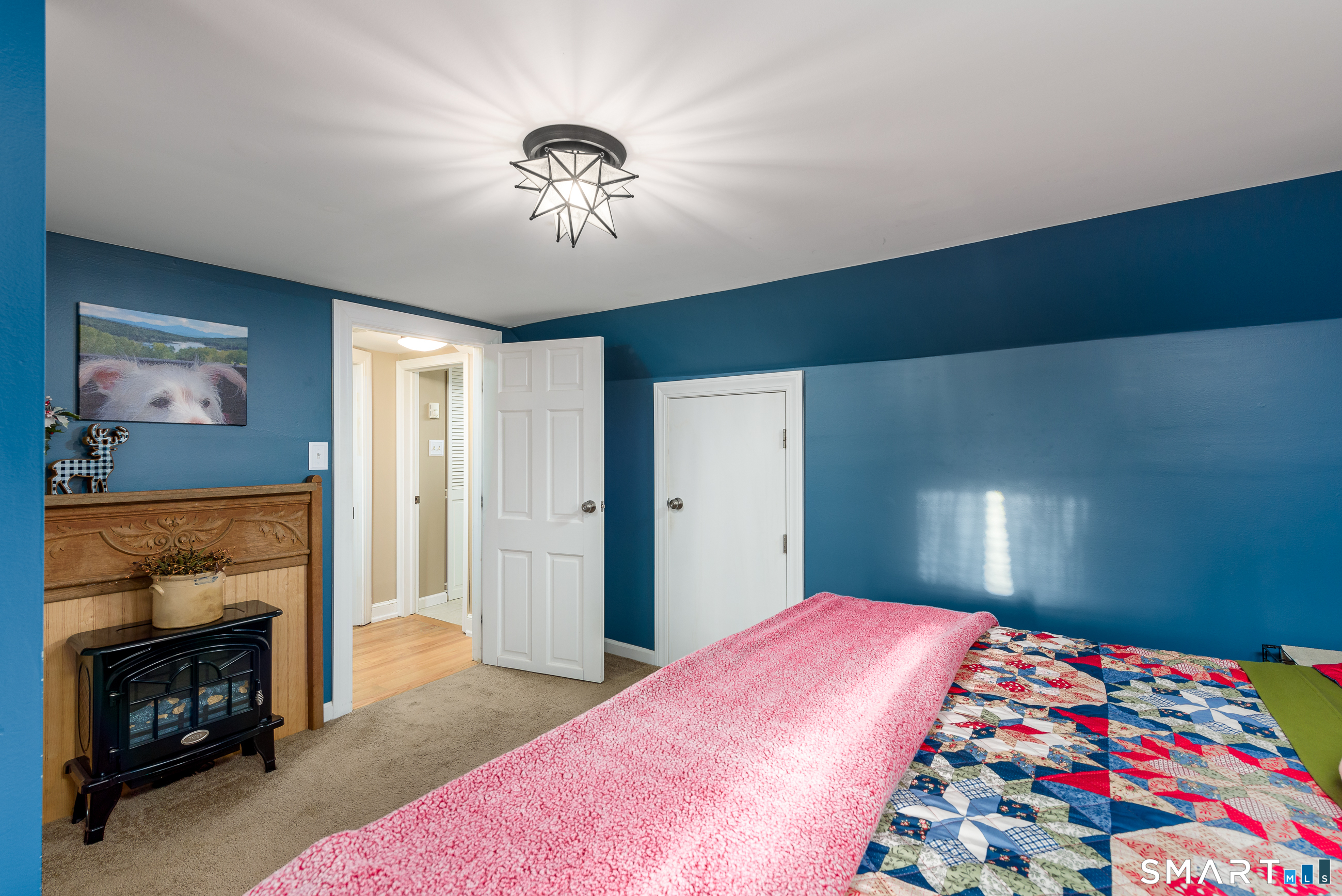 214 Thayer Road Haddam, CT 06441 - Photo 22 of 39 a bedroom with a bed and a fireplace