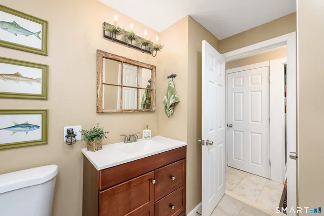 a bathroom with a sink toilet and vanity