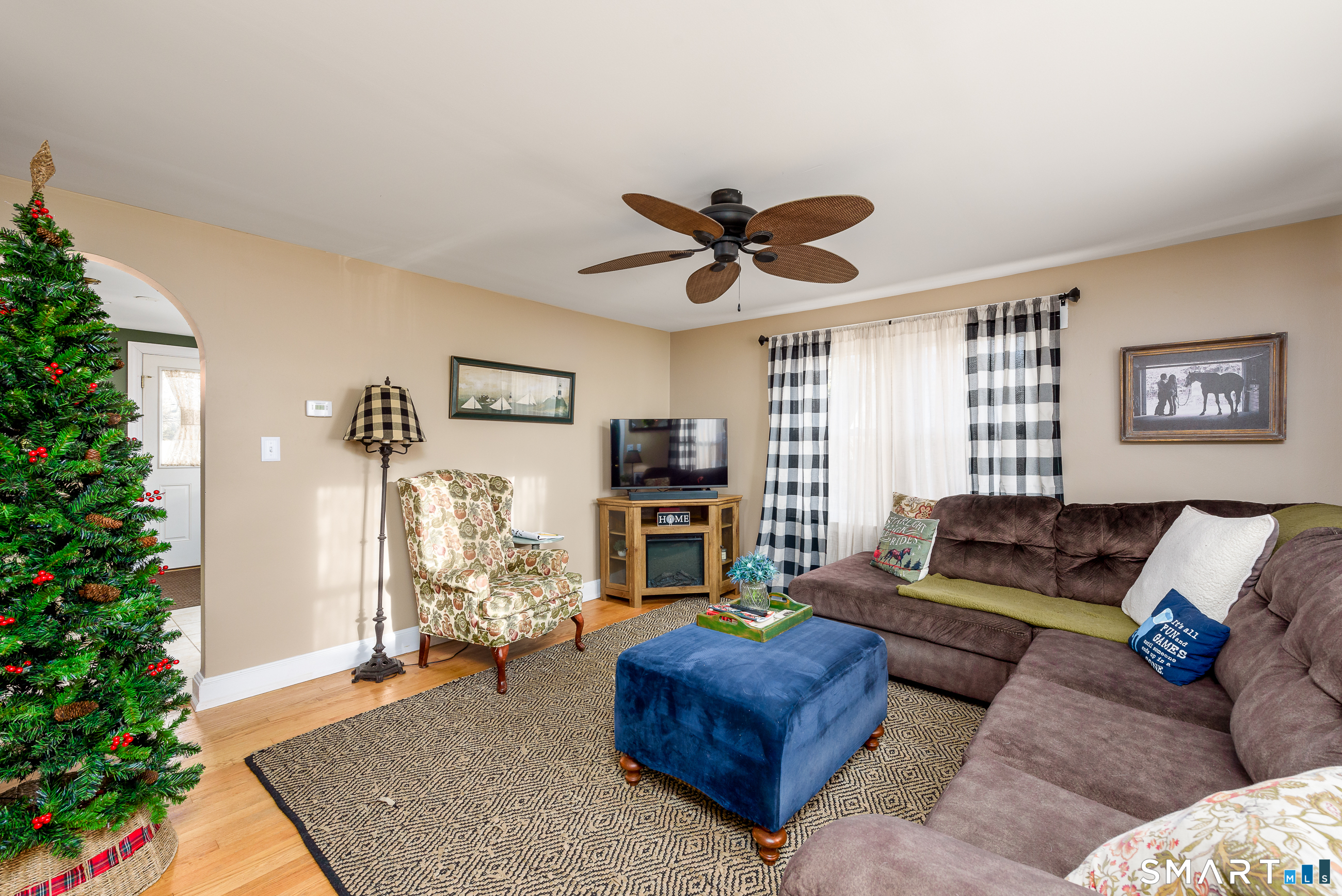 214 Thayer Road Haddam, CT 06441 - Photo 8 of 39 a living room with furniture a flat screen tv and a potted plant