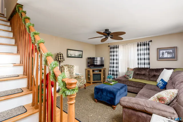 a living room with furniture a fireplace and a window
