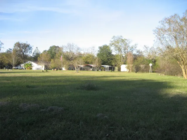 a backyard of apartments with large trees