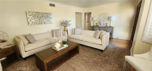 a living room with furniture a couch and a mirror