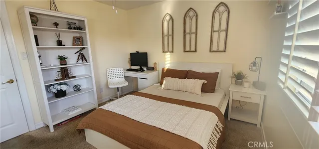 a bedroom with a bed and a book shelf