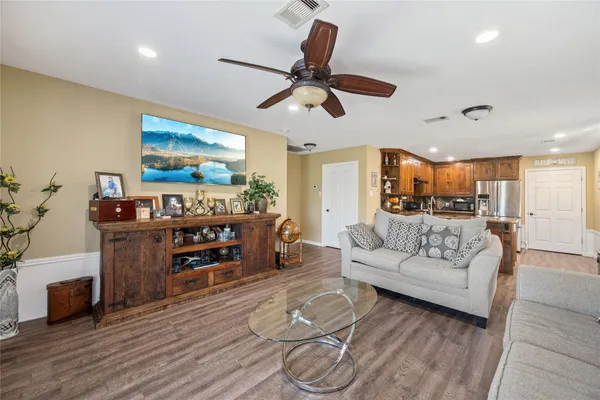 a kitchen with stainless steel appliances granite countertop a refrigerator a stove and a sink