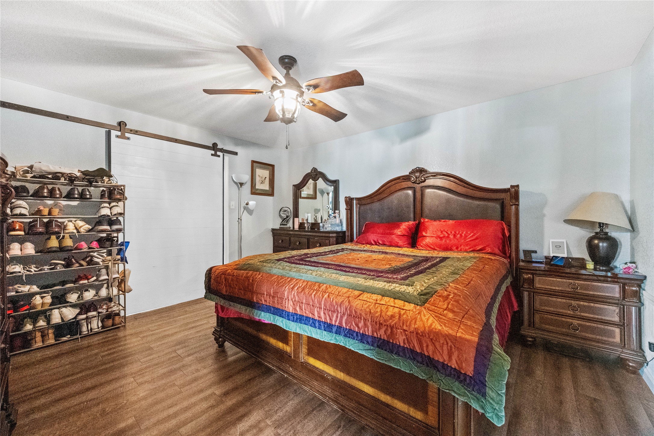 501 County Road 2276 Cleveland, TX 77327 - Photo 19 of 49 a bedroom with a bed and a chandelier