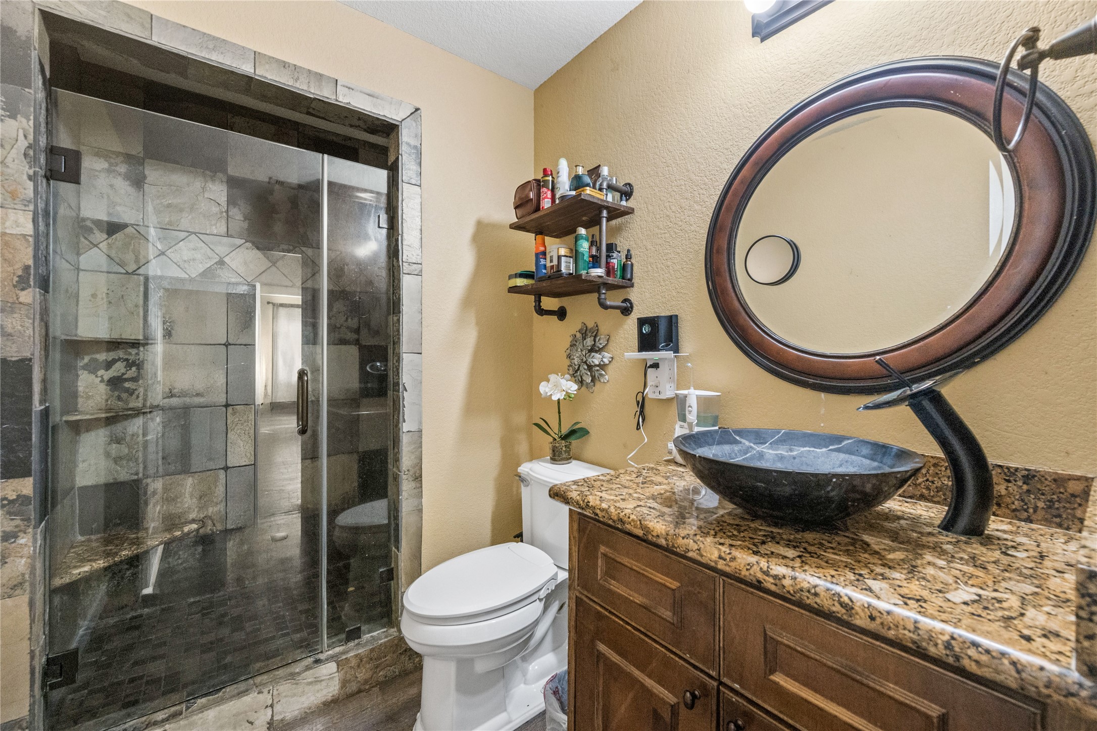 501 County Road 2276 Cleveland, TX 77327 - Photo 21 of 49 a bathroom with a granite countertop sink a toilet and a mirror