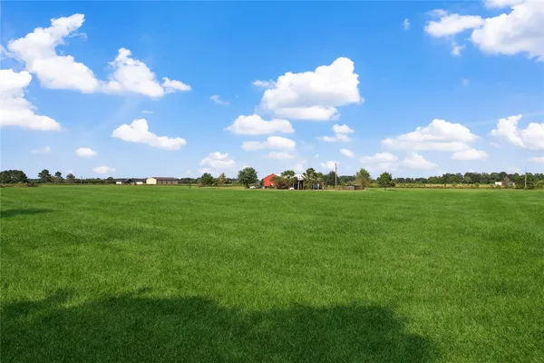 a view of swimming pool with a lake and trees in the background