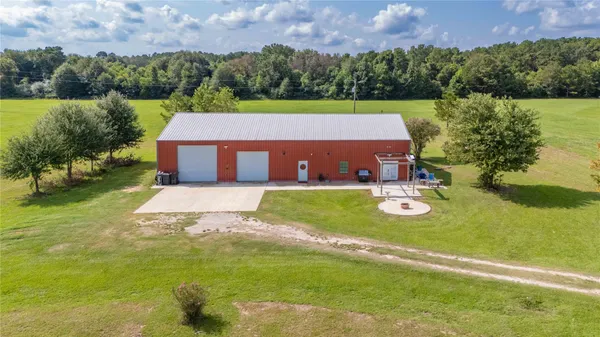a view of a green field with wooden fence