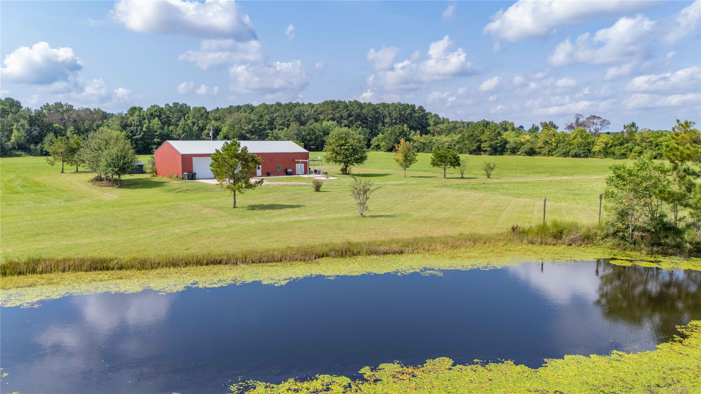 501 County Road 2276 Cleveland, TX 77327 - Photo 40 of 49 a view of a lake with a houses in the background