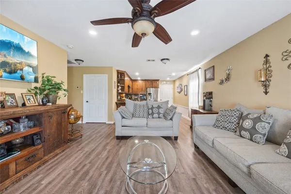 a living room with furniture and a wooden floor