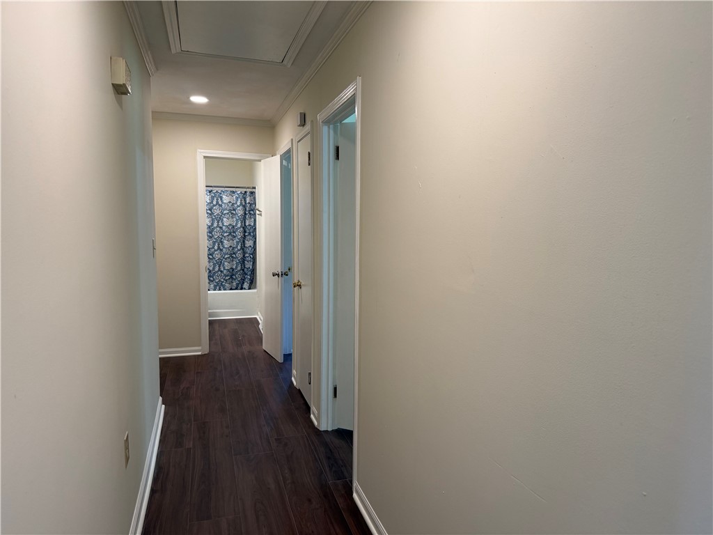 1507 East Calhoun Street Anderson, SC 29621 - Photo 9 of 18 A well-lit corridor with recessed lighting leads to a bathroom, offering seamless flow.