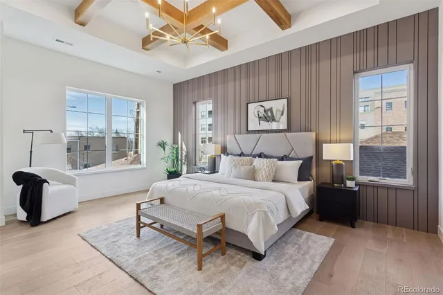 a spacious bedroom with a bed and glass window