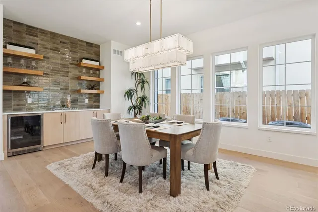 a dining room with furniture a rug and wooden floor