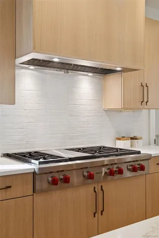 a close view of a stove top oven and cabinets