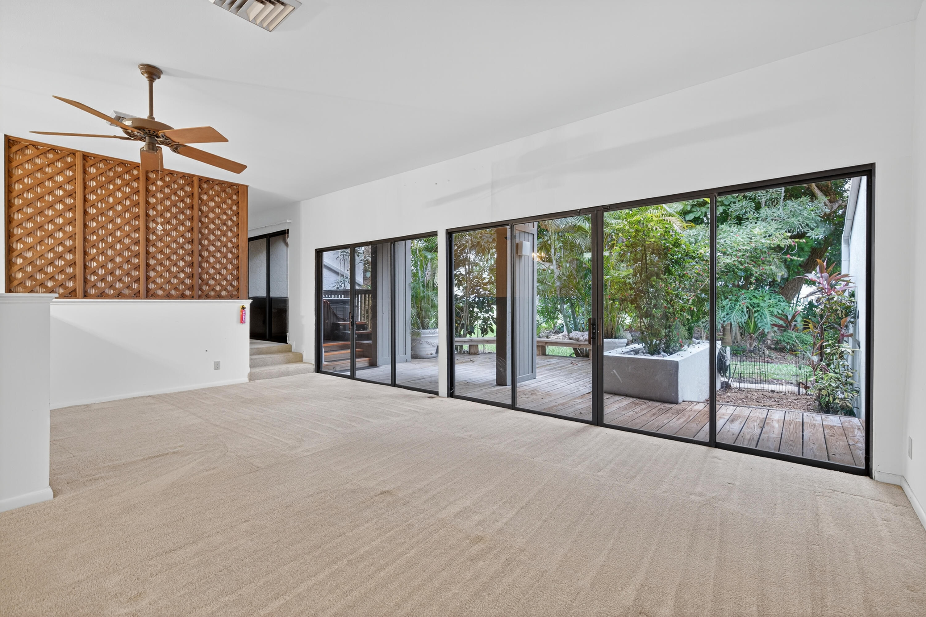 17145 Bay Street Jupiter, FL 33477 - Photo 16 of 43 a view of a big room with windows and balcony