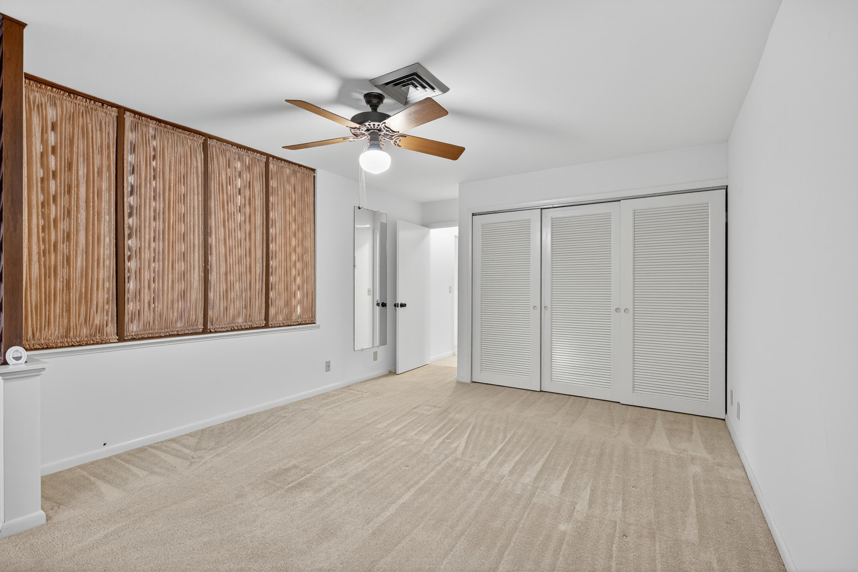 17145 Bay Street Jupiter, FL 33477 - Photo 19 of 43 a view of empty room with wooden floor and fan