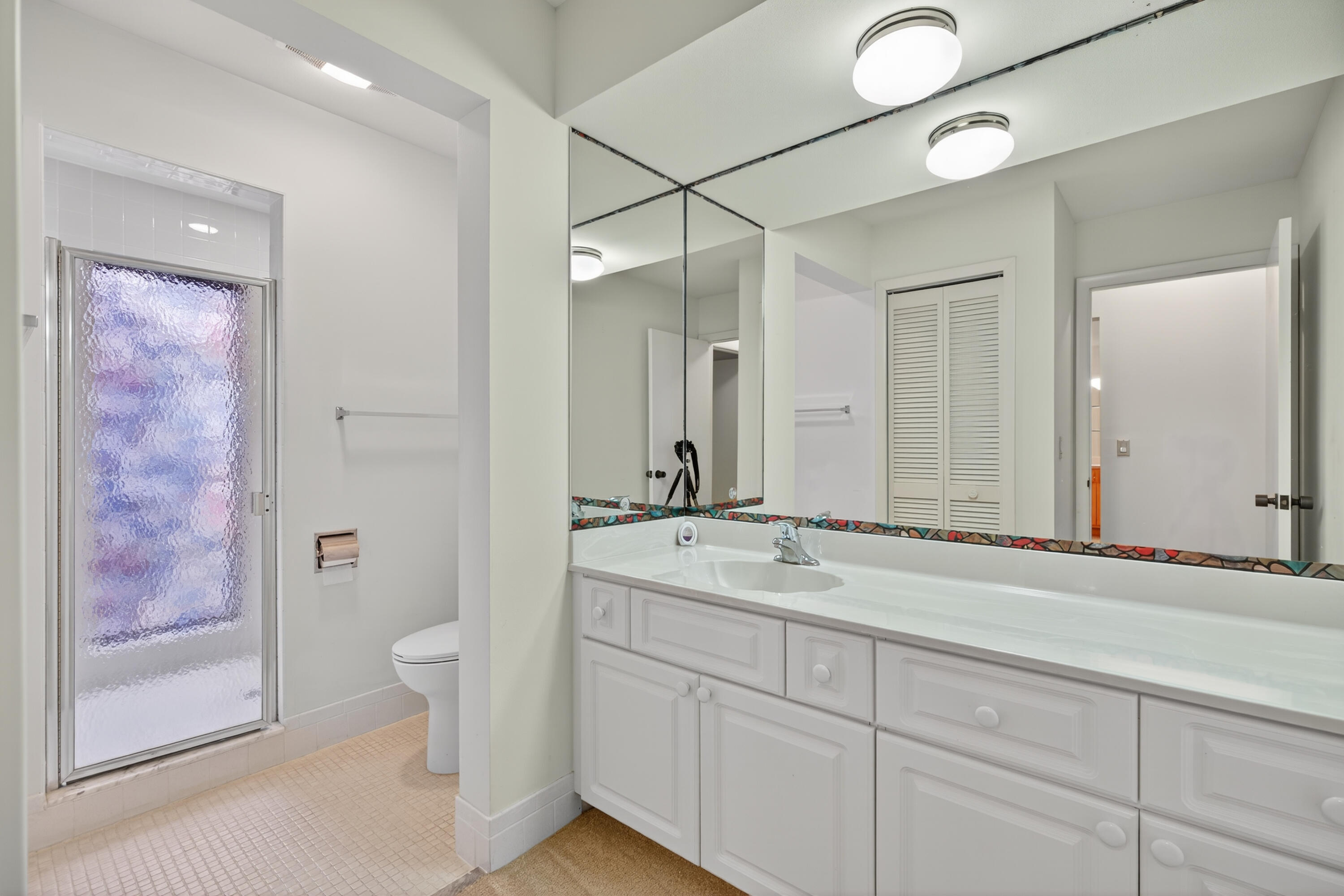 17145 Bay Street Jupiter, FL 33477 - Photo 21 of 43 a bathroom with a sink a toilet and shower