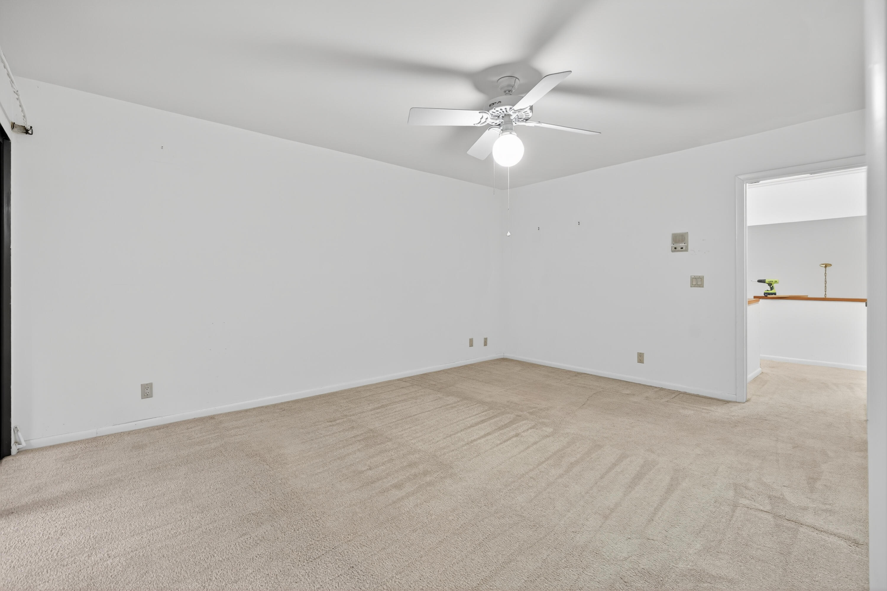 17145 Bay Street Jupiter, FL 33477 - Photo 30 of 43 an empty room with a fan and a window