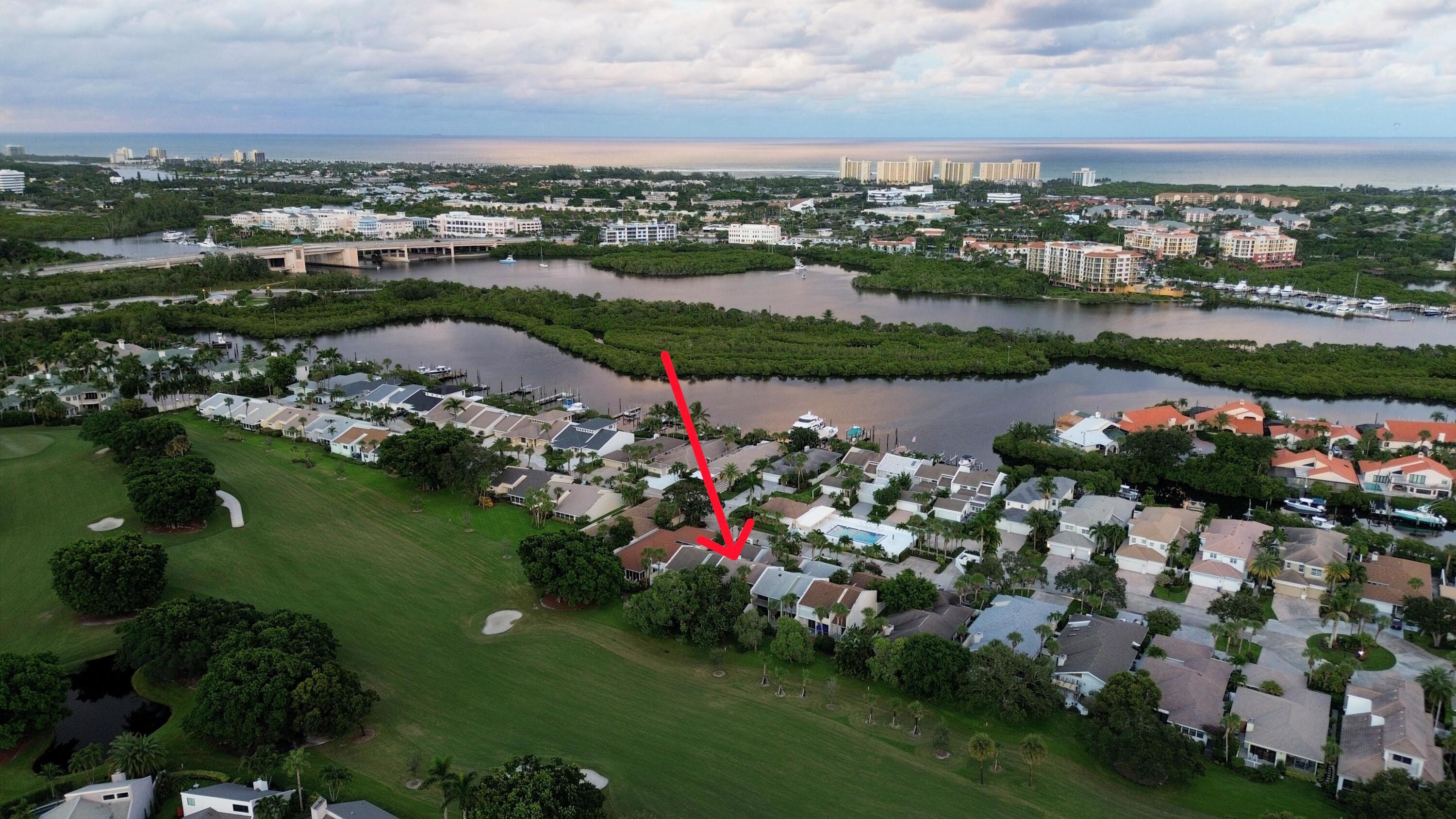 17145 Bay Street Jupiter, FL 33477 - Photo 3 of 43 an aerial view of a house with outdoor space lake view and lake view in back