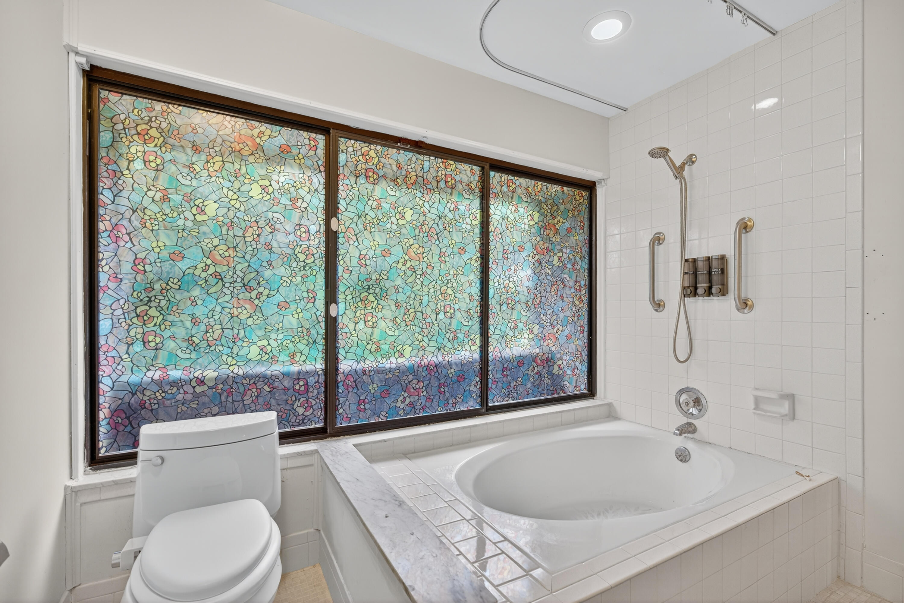 17145 Bay Street Jupiter, FL 33477 - Photo 35 of 43 a bathroom with a sink a toilet and a large window