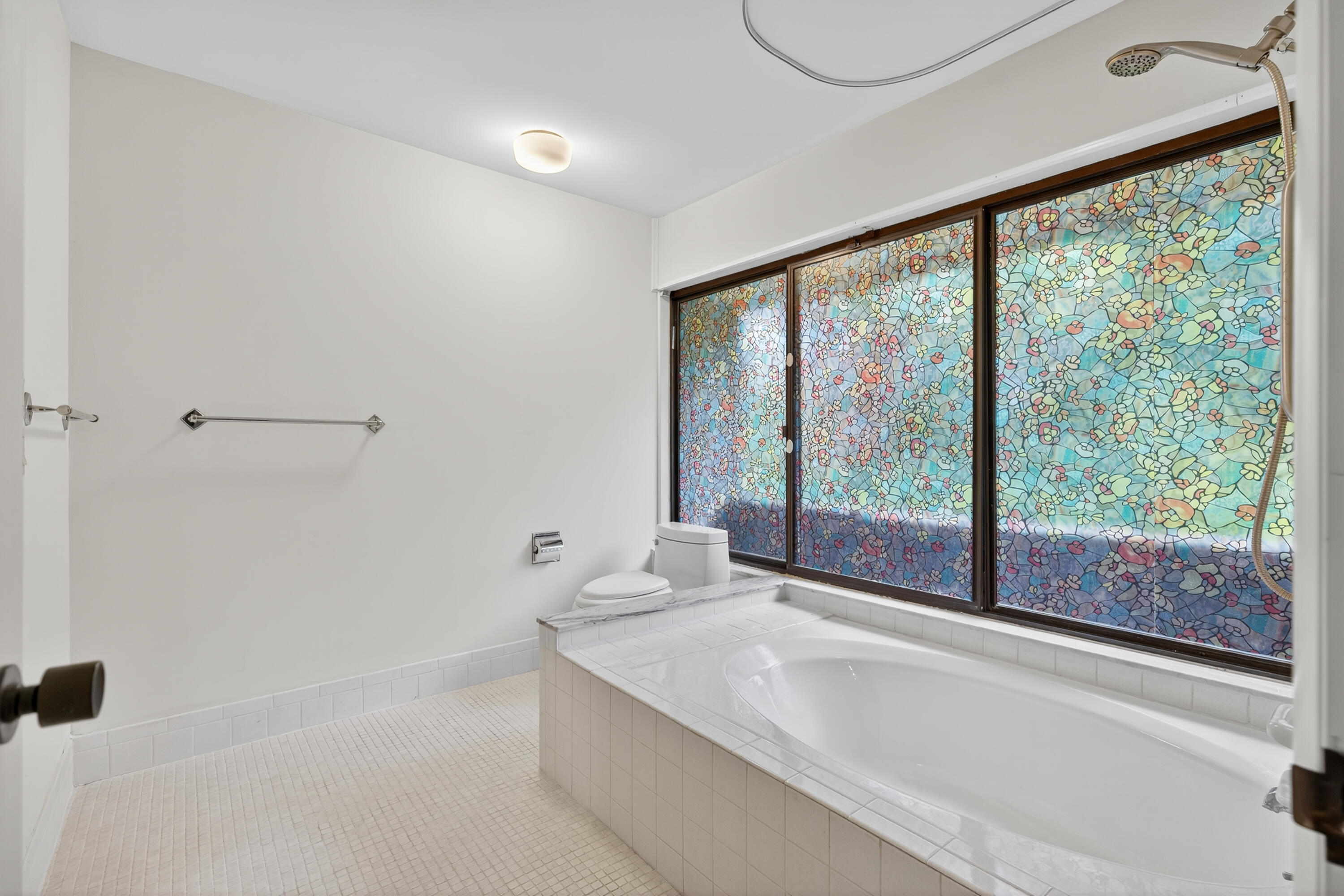 17145 Bay Street Jupiter, FL 33477 - Photo 36 of 43 a bathroom with a bathtub and next to a window