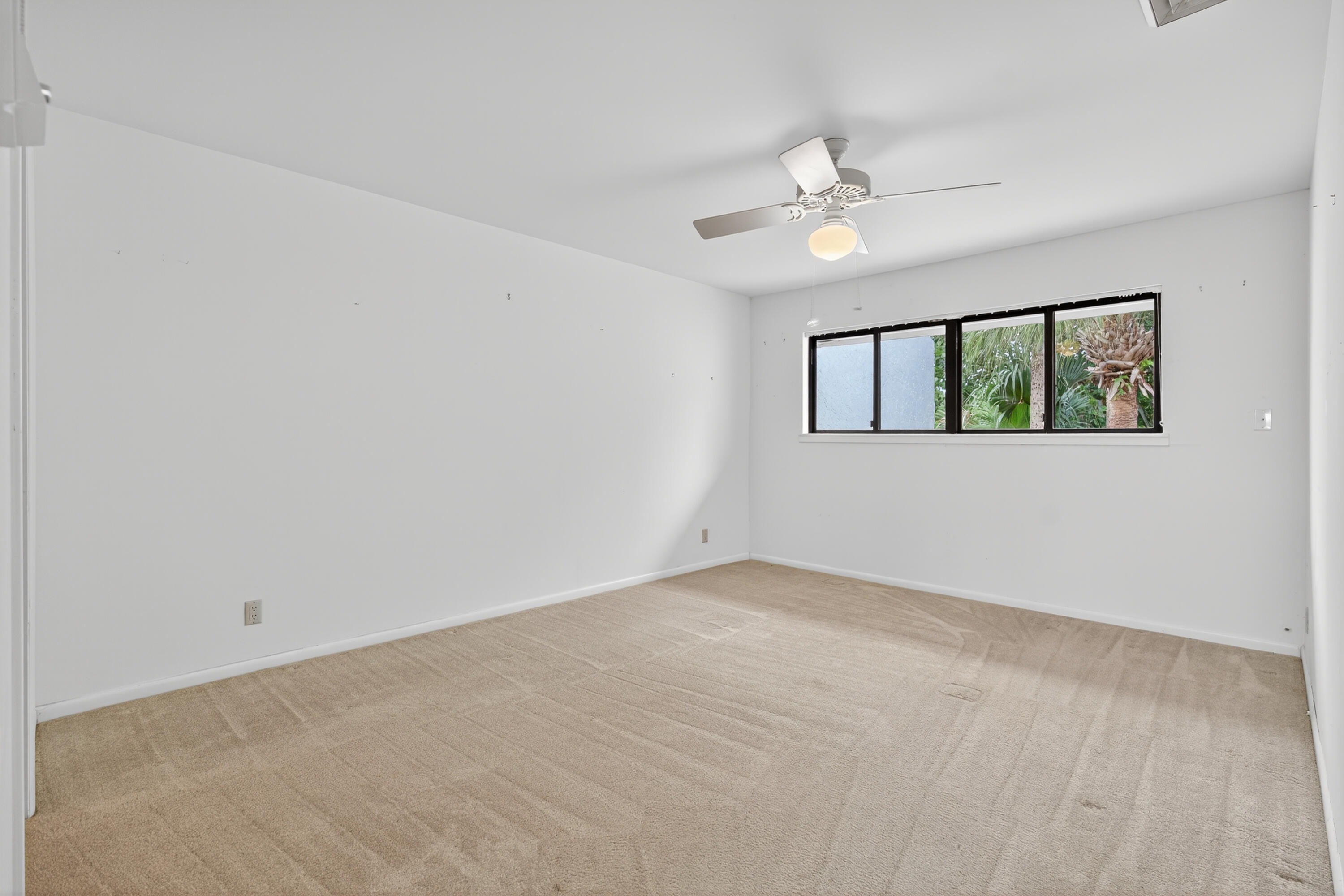 17145 Bay Street Jupiter, FL 33477 - Photo 38 of 43 an empty room with windows and fan