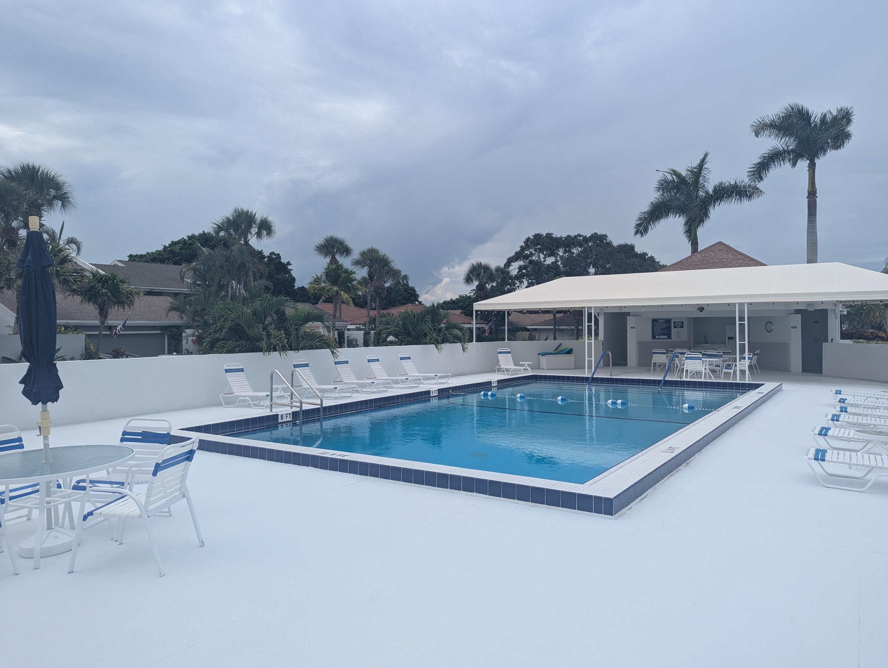 17145 Bay Street Jupiter, FL 33477 - Photo 42 of 43 a view of a house with pool and chairs